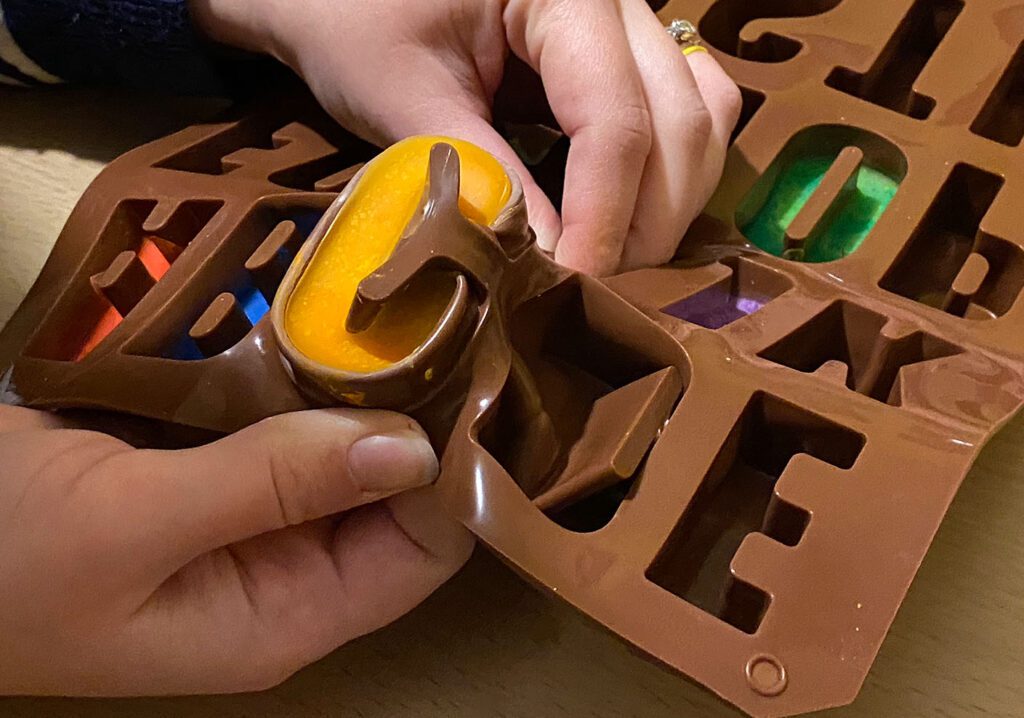 Once cooled, begin to remove the crayons from the mould