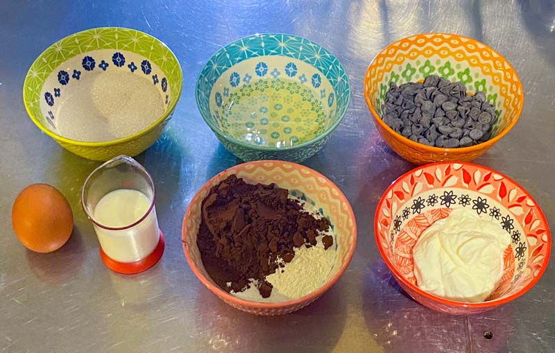 Easy air fryer recipe ingredients for double chocolate muffins layout out on a metal table.