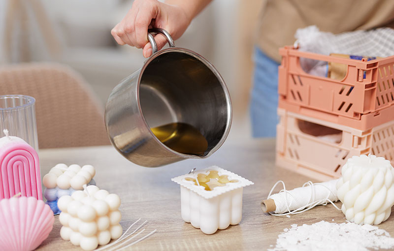 Pouring wax into a silicone mold to make candles, best candle wax