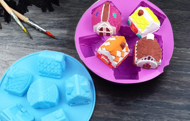 Mini cement houses next to the silicone mould used to create them