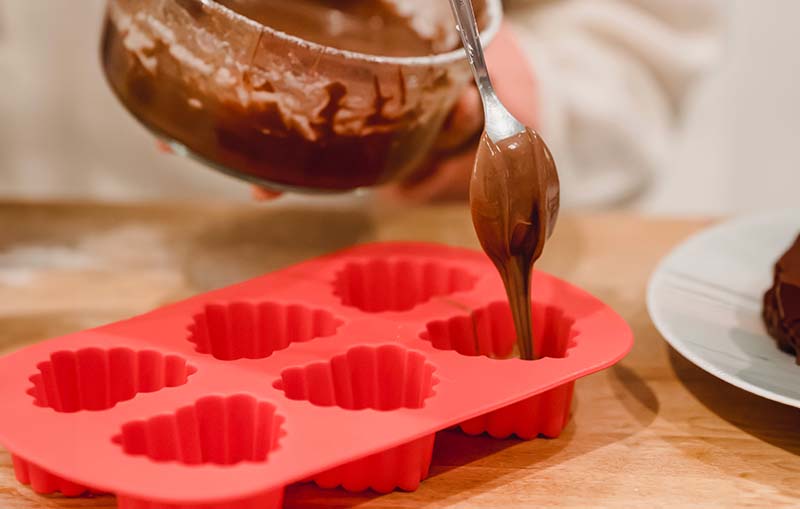 Filling a silicone mold with chocolate