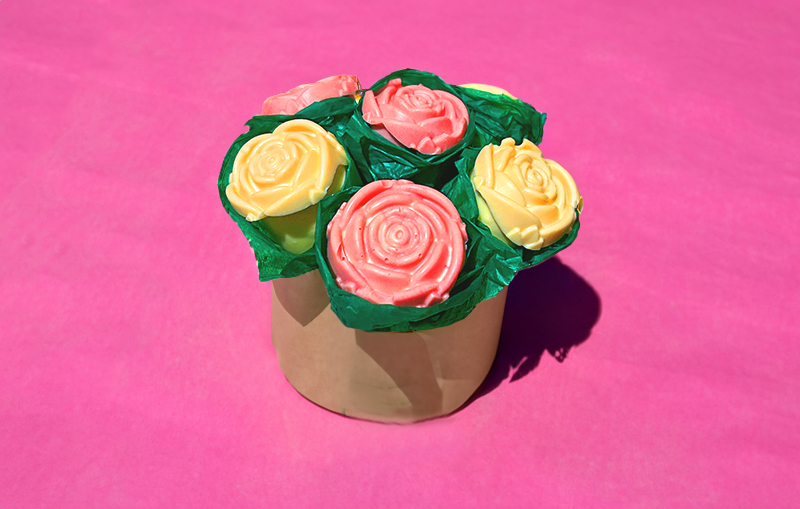 Bouquet of chocolate roses on a pink table cloth