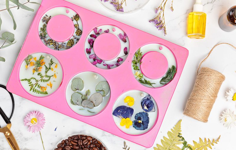 Wax melt silicone mould on a table surrounded by craft materials